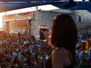 Palestinians and foreign visitors gather at the 2012 Taybeh Oktoberfest beer festival in the West Bank Christian village of Taybeh, near Ramallah. (AFP/Marco Longari)  