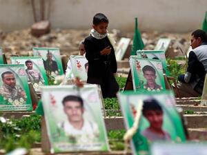 Yemenis visit the grave of relatives reportedly killed by Saudi-led coalition forces. (AFP/file) 