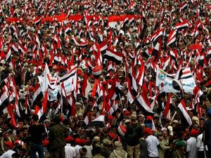 Yemenis wave the national flag during a gathering in support of the Huthi-led parliament, in the capital Sanaa on August 20, 2016. (AFP/File)