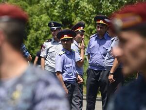 Armenian police officers stand guard as they block the streets to Erebuni police station in Yerevan on July 17, 2016. An armed group with links to an imprisoned opposition leader on July 17, 2016 seized a police building in Yerevan and took hostages, the national security service said. (AFP/Karen Minasyan) Armenian police officers stand guard as they block the streets to Erebuni police station in Yerevan on July 17, 2016. An armed group with links to an imprisoned opposition leader on July 17, 2016 seized a police building in Yerevan and took hostages, the national security service said. (AFP/Karen Minasyan)