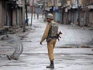 Soldier walks aside barbed wire in Kashmir (AFP/ File Photo)