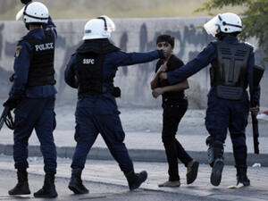 A Bahraini boy is arrested during clashes with riot police in the village of Daih, west of Manama on 19 June, 2014. (AFP)