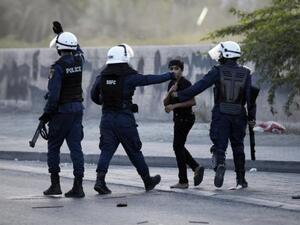 Bahraini police officers escort a child away from the scene of demonstrations in 2015. (AFP/File) Bahraini police officers escort a child away from the scene of demonstrations in 2015. (AFP/File)