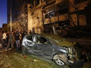 Security officials and civilians survey the aftermath of an explosion outside of Blom Bank in Beirut on the night of June 12, 2016. (AFP/Anwar Amro) Security officials and civilians survey the aftermath of an explosion outside of Blom Bank in Beirut on the night of June 12, 2016. (AFP/Anwar Amro)