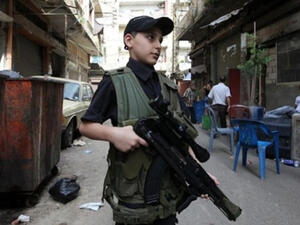 This young Lebanese chap has a gun almost bigger than his own body. (image courtesy of Gino's Blog)