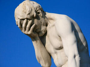 A statue illustrates a classic form of the #facepalm.