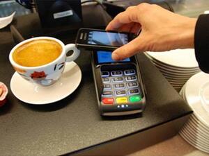Going cashless can range from consumers paying through mobile payment applications on their smartphones, to paying through the latest wearable devices such as smart watches. (File photo)