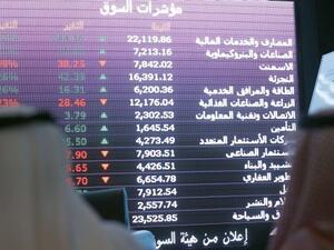 Investors monitor stocks at Saudi Arabia's National Commercial Bank. (AFP/File)