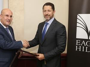Previous CEO Alaa Batayneh (R) during a signing ceremony with Jordan Ahli Bank on August 7, 2016. (Courtesy of Eagle Hills)