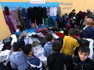 People line up to try on clothes at the Charity Wall in Erbil. (AFP/Safin Hamed)
