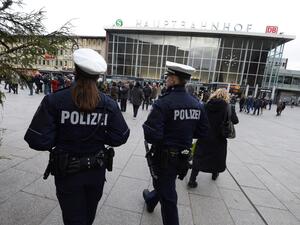 Police officers survey the area in front of the main train station and the Cathedral in Cologne, Germany, where dozens of apparently coordinated sexual assaults occurred on New Year's Eve. (AFP/Roberto Pfeil)