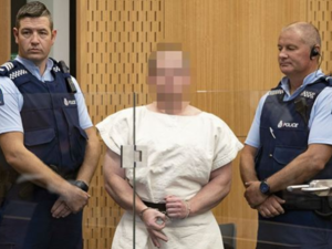 Accused Christchurch massacre gunman Brenton Harrison Tarrant (pictured) has made a white power gesture from behind a glass window, during a brief appearance in court (Twitter)