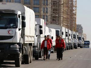 The aid convoy goes through final preparations before departing from Damascus. (AFP/Louai Beshara)