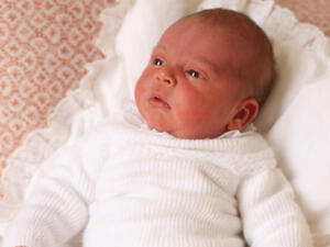 Louis appears wide awake in a white outfit as he gazes at something out of shot of the camera (Source: Kensington Palace - Twitter)