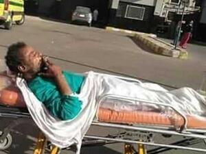 widespread photos of a patient who was allowed to smoke a cigarette, while being moved in a trolley on hospital grounds in Egypt. (Twitter)