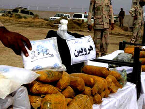 An Iranian officer displays packages of seized Afghan-made drugs (AFP) An Iranian officer displays packages of seized Afghan-made drugs (AFP)