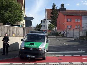 A pliceman stands near a migrant reception center on July 27, 2016 in Zirndorf, southern Germany, following an explosion of a suitcase. (AFP/Daniel Karmann) A pliceman stands near a migrant reception center on July 27, 2016 in Zirndorf, southern Germany, following an explosion of a suitcase. (AFP/Daniel Karmann)