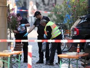 Police investigators work at the site of a suicide bombing in Ansbach, southern Germany, on July 25, 2016. (AFP/Daniel Karmann) Police investigators work at the site of a suicide bombing in Ansbach, southern Germany, on July 25, 2016. (AFP/Daniel Karmann)
