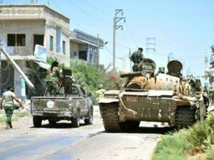 آليات عسكرية سورية تتمركز في بلدةالغارية الغربية على مسافة حوالى 15 كلم شرق درعا
