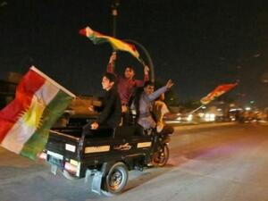 عراقيون أكرد يلوحون بالاعلام الكردية أثناء مرورهم في مواكب سيارة في شوارع كركوك في شمال العراق
