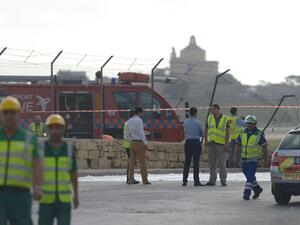 Emergency workers are seen at the site of the wreckage of a small twin engined plane which crashed shortly after takeoff from Malta International Airport, on October 24, 2016. (AFP/Matthew Mirabelli)
