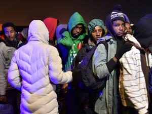 Migrants queue for transportation by bus to reception centres across France, from the "Jungle" migrant camp in Calais, northern France, on October 24, 2016. (AFP/Philippe Huguen)