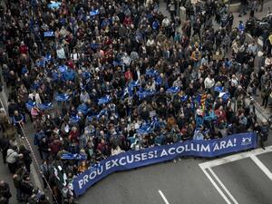 Tens of thousands of people march holding a banner reading "Enough excuses! Let's welcome them now" in a street of Barcelona during a pro-refugee demonstration on February 18, 2017. (AFP/Josep Lago)