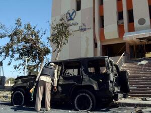 A police officer inspects the scene of a car bomb carried out earlier in Egypt's Sinai Peninsula. (AFP/File)