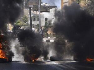 Black smoke rises from tires set on fire by demonstrators outside the Luxor town house protesting against the appointment of Adel al-Khayat (AFP)