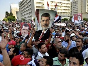 Pro-Muslim Brotherhood protesters hold banners in support of ousted Egyptian president Mohammed Mursi (AFP)