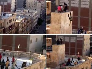  A combo of image grab taken from a video uploaded to YouTube on July 5, 2013, shows an unidentified group of men taking refuge atop of a building while being surrounded by another group of men (Top-L), hurled of a ledge onto the roof of a building (Top-R, Bottom-L), and then beaten (Bottom-R) (Youtube / AFP)