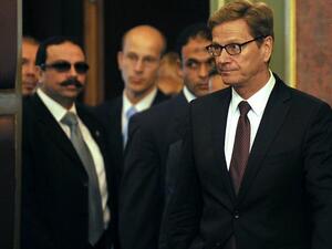 EGYPT, Cairo : German Foriegn Minister Guido Westerwelle (R) arrives with his Egyptian counterpart Nabil Fahmy (unseen) to give a joint press conference following their meeting in Cairo on August 1, 2013. AFP PHOTO/FAYEZ NURELDINE