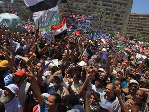 EGYPT, Cairo : Supporters of ousted president Mohamed Morsi shout slogans during a demonstration in support of Morsi in Cairo, on August 9, 2013. AFP PHOTO/ AHMED MAHMOUD