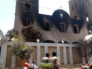 EGYPT, MINYA : A picture taken on August 14, 2013, shows the facade of the Prince Tadros Coptic church after being torched by unknown assailants in the central Egyptian city of Minya. AFP PHOTO/STR
