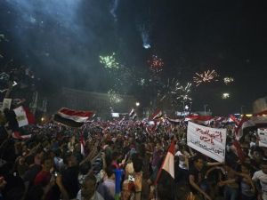 People celebrate in Tahrir Square after the army overthrew President Mohamed Morsi (AFP)