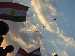 Egyptian army helicopters fly over as hundreds of thousands of Egyptian demonstrators gather outside the presidential palace in Cairo (Khaled Desouki / AFP)