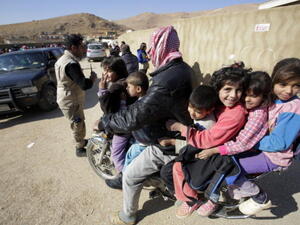 Syrians who fled recent violence in the mountainous Qalamoun region, waiting to be registered by the United Nations High Commissioner for Refugees (UNHCR) on November 19, 2013 in Arsal. [Getty Images]