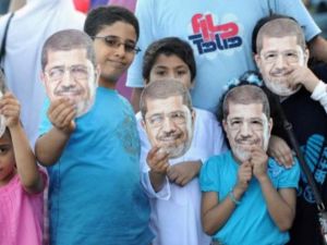 اطفال مع زويهم المؤيدين للرئيس المعزول في الاسكندرية عقب صلاة عيد الفطر/أ.ف.ب