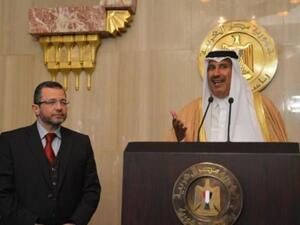 Egypt Prime Minister Hisham Qandil with Qatar's Premier and Foreign Minister Sheikh Hamad bin Jassem bin Jabr al-Thani in Doha