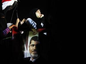 Protestor raises specter of deposed Morsi at Cairo rally turned violent, July 7 (Image Mahmoud Khaled / AFP)