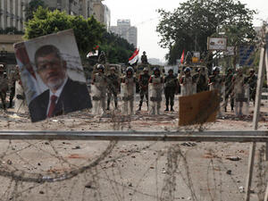 Soldiers of the Egyptian Army stand guard near the headquarters of the Egyptian Republican Guard one day after a shooting at the site of a pro-Morsi sit in (Image credit: Getty)