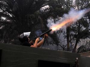 An Egyptian riot policeman fires tear gas in Cairo, Egypt. [csgazette]