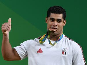 Egypt's Mohamed Mahmoud poses with his bronze medal on the podium of the Men's 77kg weightlifting competition at the Rio 2016 Olympic Games. (AFP/GOH Chai Hin)