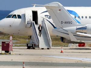 The alleged hijacker disembarks before surrendering to security forces after a six-hour standoff on the tarmac at Larnaca airport's largely disused old terminal on March 29, 2016. (AFP/George Michael)