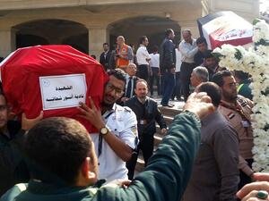 Egyptian mourners and officials carry the coffins of the victims of a bomb explosion that targeted a Coptic Orthodox Church the previous day in Cairo, at the end their funeral in the capital's Nasr City neighbourhood on December 12, 2016. (AFP/Khaled Desouki)