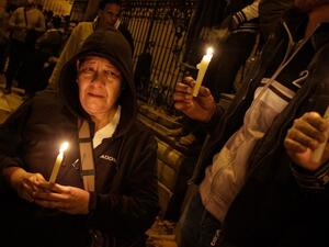 Egyptians carry candles during a vigil for the victims of a bomb explosion that targeted the Saint Peter and Saint Paul Coptic Orthodox Church on December 11, 2016, in Cairo's Abbasiya neighborhood. (AFP/Suhail Saleh)