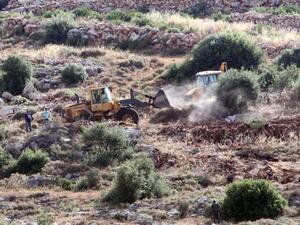 Bulldozers clear land for a new settlement in the West Bank village of Wadi Fukin. ( AFP/File)