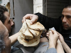 Egyptians gather to buy bread in central Cairo on 31 January 2011. (AFP)