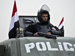 An Egyptian policeman stands guard from an armoured vehicle outside the venue of the trial of the ousted Islamist president Mohammed Morsi. (AFP/ File Photo)