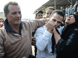 An Egyptian man embraces his parents following his release from prison in Cairo on March 14, 2017, along with 202 other prisoners who received a presidential pardon. (AFP)